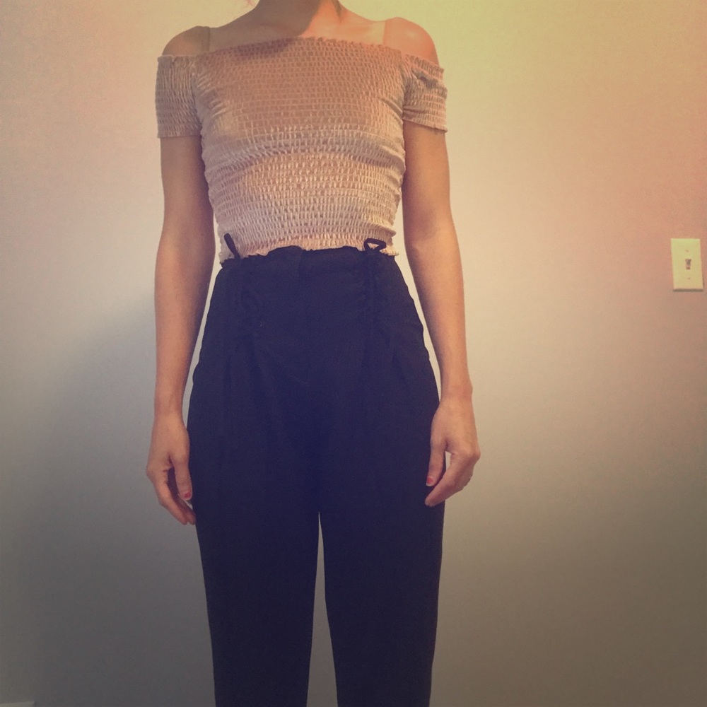 High-waisted pleated pants with lace-up features.